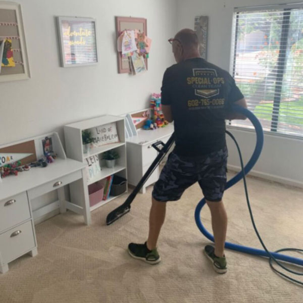 A Special Ops Clean Team technician cleaning the carpet in a Phoenix, AZ area home